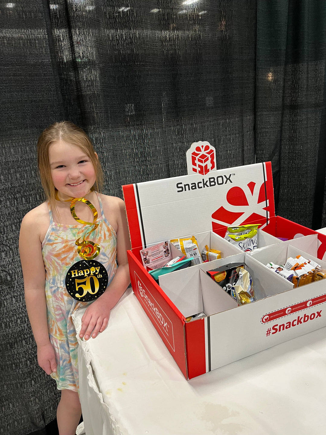 Photo of girl with large office 150 count snack box for birthday party